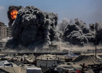 Cercado por tendas de palestinos desabrigados, mais um edifício bem abaixo sob bombas despejadas por Israel   Foto: Reprodução/Internet